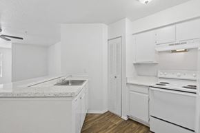 Sanford apartment for rent - A white kitchen with a sink and stove.