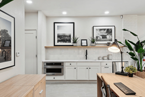 Austin apartment for rent - a kitchen with white cabinets and a wooden counter top