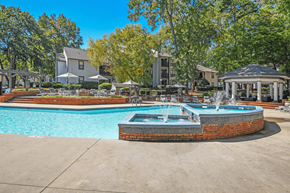 Matthews apartment for rent - A pool with a fountain in the middle of it at Paces Pointe Apartment Homes, North Carolina, 28105