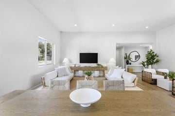 Davie apartment for rent - A modern living room with a white sofa set, a wooden coffee table, and a flat-screen TV.