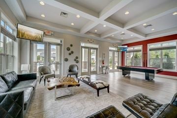Morrisville apartment for rent - A living room with a black leather couch and a wooden coffee table.