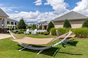 Morrisville apartment for rent - A lawn with a hammock and a house in the background.