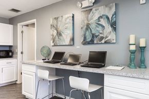 Wesley Chapel apartment for rent - an office with three laptops on a counter with chairs