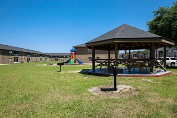 Sitting area with picnic tables and bbq grill