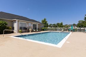 Vero Beach apartment for rent - Swimming Pool with Lounge Seating and Building Exterior in the Background