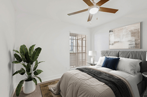 Austin apartment for rent - a bedroom with a bed and a ceiling fan