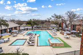 Austin apartment for rent - a pool with chairs and umbrellas at the resort on a sunny day