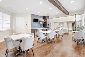 Aventura apartment for rent - A modern dining room with a white table and chairs.