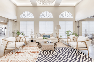 Aventura apartment for rent - A living room with a rug and chairs.