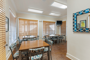 Denton townhouse for rent - a dining room with tables and chairs and a painting on the wall