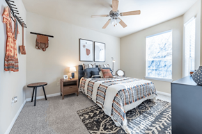 Austin apartment for rent - a bedroom with a bed and a ceiling fan