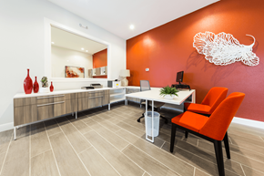 Austin apartment for rent - an office with orange chairs and a white bird on the wall