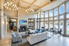 Mansfield apartment for rent - a resident clubhouse with a fireplace and large windows with sitting area