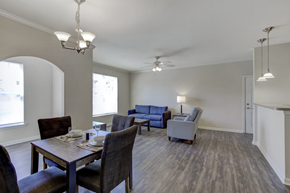 Knoxville apartment for rent - A dining room with a table set for two and a couch in the background.