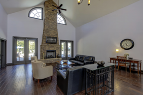 Knoxville apartment for rent - A living room with a stone fireplace and a clock on the wall.