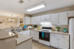 Brunswick apartment for rent - A kitchen with white cabinets and a stove top oven.
