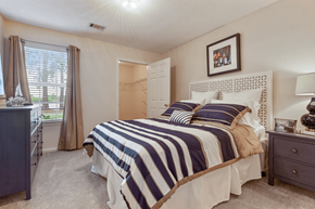 Brunswick apartment for rent - A bedroom with a bed, nightstand, and window.