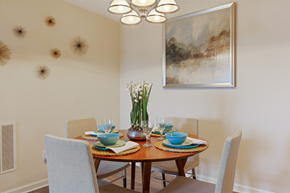 Brunswick apartment for rent - a dining room with a table and chairs and a painting on the wall