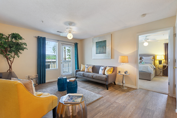 Brunswick apartment for rent - A living room with a yellow chair and a grey couch.