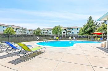 Pool deck with chaise lounges and umbrella seating