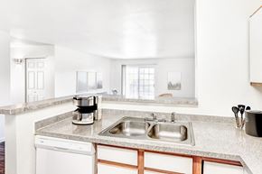Brighton apartment for rent - Kitchen with double sink and granite countertops at Riverwalk Apartments, Colorado