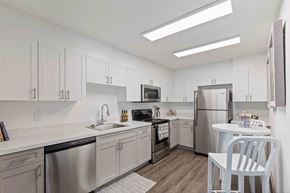 Savannah apartment for rent - A kitchen with white cabinets and stainless steel appliances.