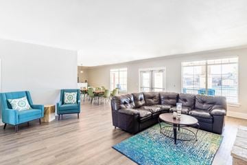 Austin apartment for rent - A living room with a blue couch and a black couch.