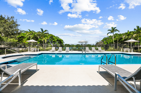 Lake Park apartment for rent - a swimming pool with lounge chairs and umbrellas