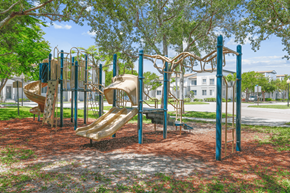 Lake Park apartment for rent - a playground with slides and monkey bars at the whispering winds apartments in pearland, tx
