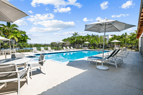 Lake Park apartment for rent - a swimming pool with lounge chairs and umbrellas