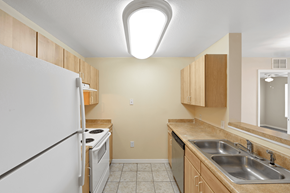 Lakeland apartment for rent - a kitchen with wood cabinets and white appliances