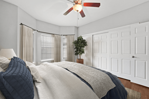 Tyler apartment for rent - a bedroom with a large bed and a ceiling fan