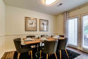 Knoxville apartment for rent - staged dining room with hardwood-style flooring and patio door