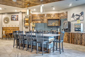Nashville apartment for rent - A kitchen with a wooden wall and a large island with chairs around it.