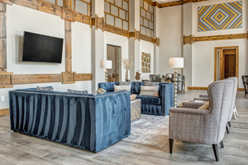 Nashville apartment for rent - A living room with a blue sofa and a grey armchair.