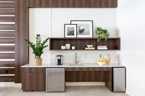 Orlando apartment for rent - A modern kitchen with a wooden cabinet and a white backsplash.
