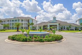 Plant City apartment for rent - A building with a pool in front of it.