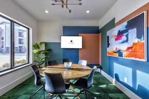 Burleson apartment for rent - A conference room with a table, chairs, and a painting on the wall.