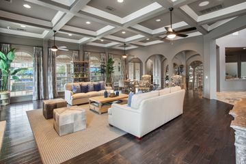 Pflugerville apartment for rent - A spacious living room with a white sofa and a rug.