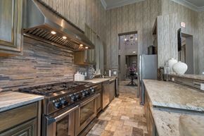 Pflugerville apartment for rent - A kitchen with a stove top oven and a tile floor.