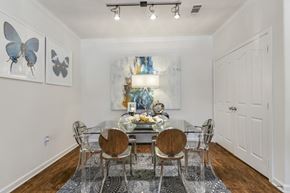Pflugerville apartment for rent - A dining room with a table set for four and a painting of a butterfly on the wall.