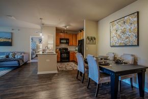 Jacksonville apartment for rent - A modern kitchen with a dining table set for four.