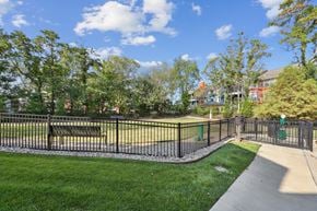 Louisville apartment for rent - A park with a fence, bench, and trees.