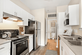 Charlotte apartment for rent - a kitchen with white cabinets and stainless steel appliances