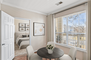 Charlotte apartment for rent - a dining area with a table and four chairs and a large window with blinds