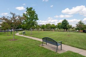Waldorf apartment for rent - a park bench sitting in the middle of a grass field