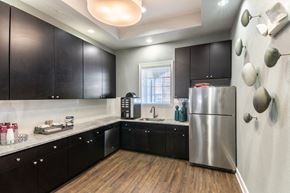Kissimmee apartment for rent - a kitchen with black cabinets and a stainless steel refrigerator