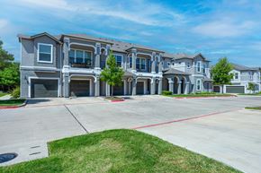 Austin apartment for rent - A row of apartments with grey exteriors and red outlines on the driveways.