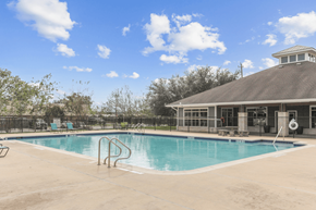Pasadena apartment for rent - A swimming pool with a diving board and a small building in the background.