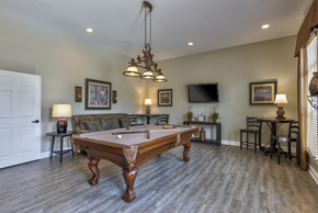 Nashville apartment for rent - A pool table is in the middle of a room with a tv and a couch.